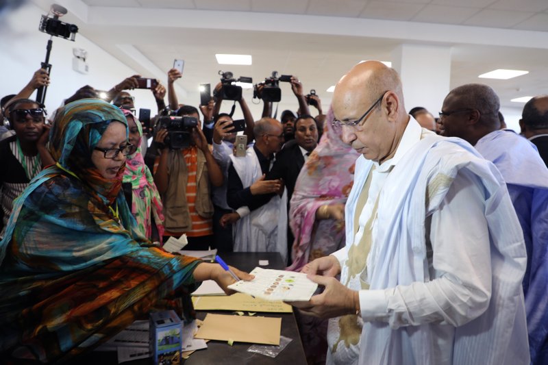 Ruling party presidential candidate and former Defense Minister Mohamed Ould El Ghazouani casts his ballot in Nouakchott, Mauritania, Saturday June 22, 2019. Mauritanians are choosing between outgoing President Mohamed Ould Abdel Aziz's heir apparent and five opposition candidates who believe the front-runner would represent a continuation of his rule in this West African country battling Islamic extremism. 