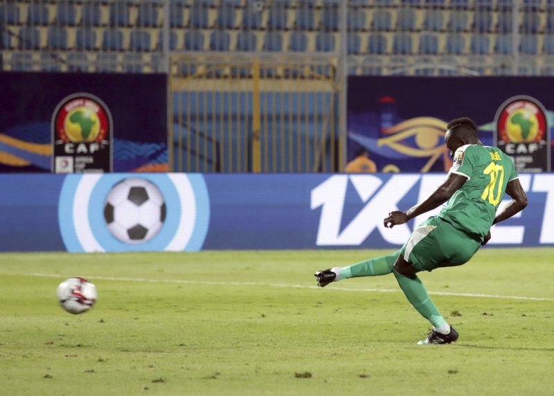 Senegal's Sadio Mane scores his side's third goal from the penalty spot during the African Cup of Nations group D soccer match between Kenya and Senegal in 30 June Stadium in Cairo, Egypt, Monday, July 1, 2019. 