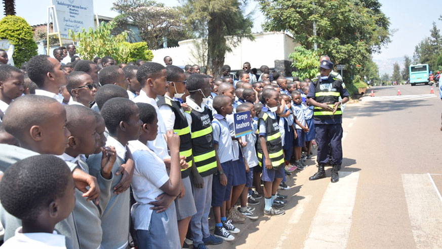 A Police officer educating students on safe usage of the road. (Courtesy)