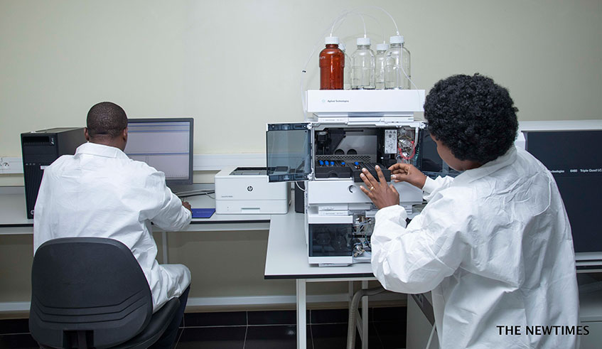 A technician places test tubes in a machine at Rwanda Forensic Laboratory. Emmanuel Kwizera.