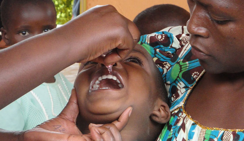 A nurse administers a vaccine to a child at Kacyiru District Hospital.