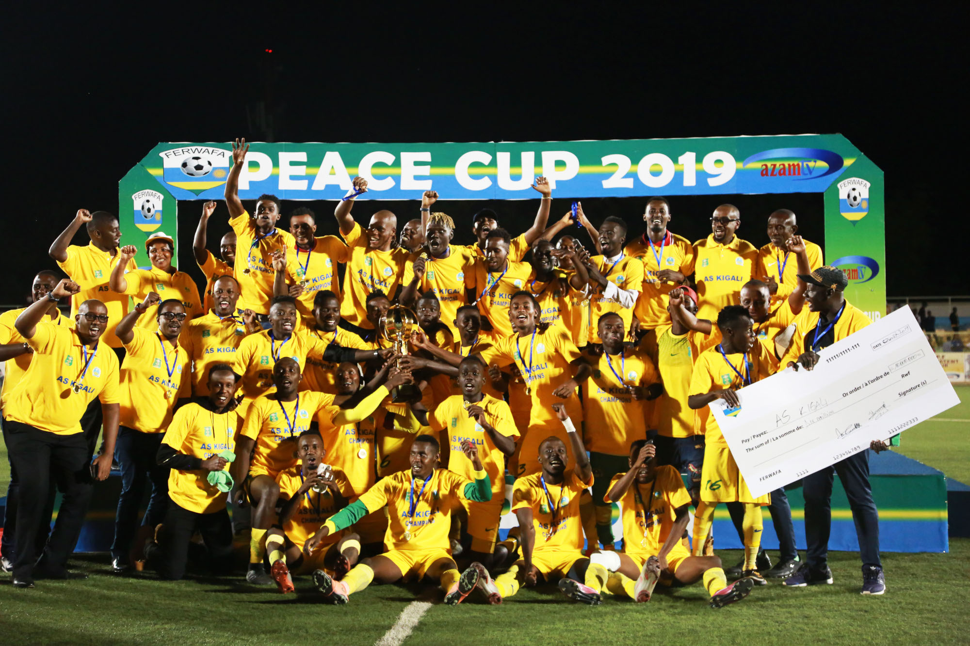 AS Kigali players and staff celebrate with the trophy and Rwf10 million dummy cheque after beating SC Kiyovu 2-1 in the 2019 Peace Cup final at Kigali Stadium on Thursday. / Sam Ngendahimana