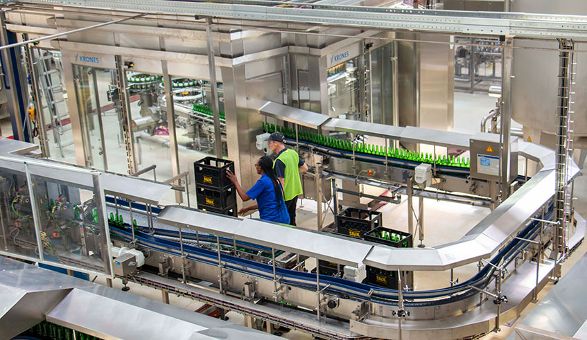 Bottles slide off an assembly line of a local beer manufacturer. According to a draft law that was presented to parliament yesterday, incentives will be offered to local beer and wine manufacturers who will use up to 70 per cent of locally-sourced raw materials. Emmanuel Kwizera.