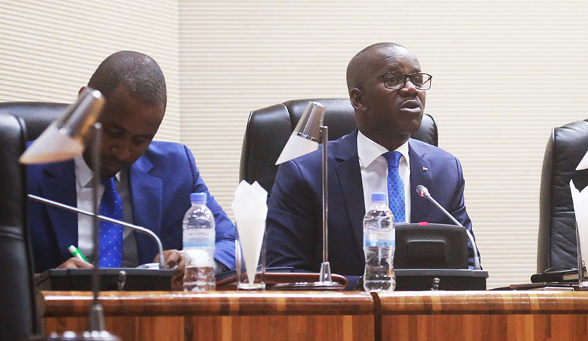 Minister of State for Constitutional and Legal affairs (C) Evode Uwizeyimana addresses parliament as State Minister for infrastructure  Uwihanganye takes notes yesterday (Sam Ngendahimana) 