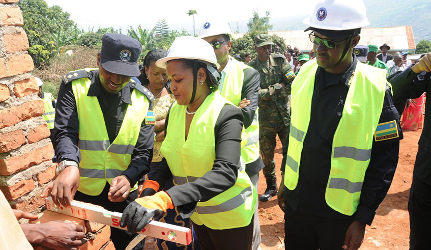 The Minister for Youth, Rosemary Mbabazi (centre), IGP Dan Munyuza (right) and a Police engineer during the launch of the Police Month outreach activities in Mageragere, Nyarugenge District. Rwanda National Police on Monday launched a month-long outreach campaign to support community development and harness the ideology of community policing in crime prevention. Courtesy.  