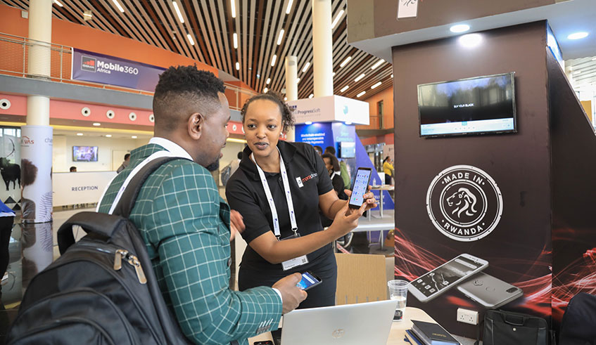 A delegate is taken through the functions of Made-in-Rwanda Mara Phone smartphone at the on-going GSMA Mobile 360 Africa conference in Kigali yesterday. Emmanuel Kwizera.