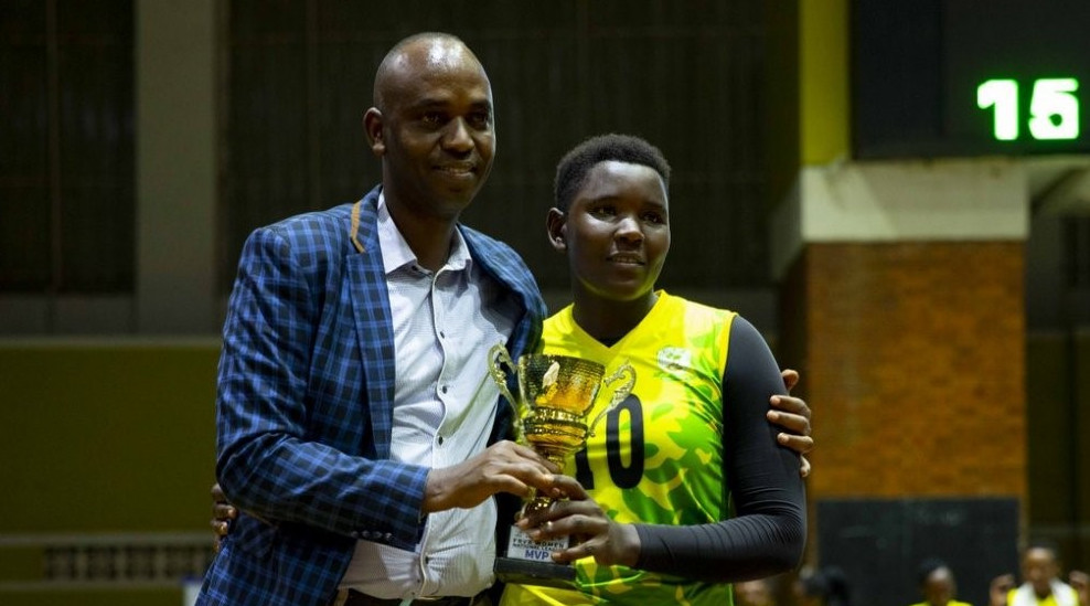 Benitha Mukandayisenga is seen here receiving her MVP award, for the 2018-19 league season, from former Rwanda Volleyball Federationu2019s president, Gustave Nkurunziza, at Amahoro Stadium last month. / Courtesy