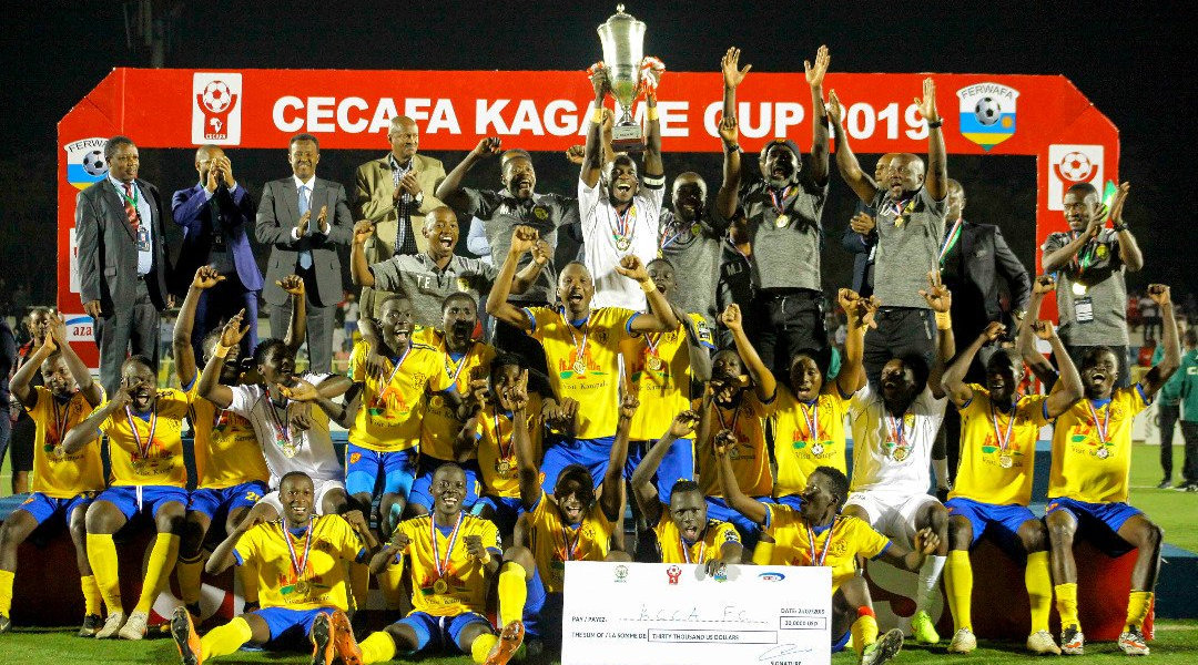 KCCA players and staff celebrate with the trophy and USD30,000 dummy cheque after beating Azam 1-0 to win this yearu2019s Cecafa Kagame Cup at Kigali Stadium on Sunday. / Courtesy
