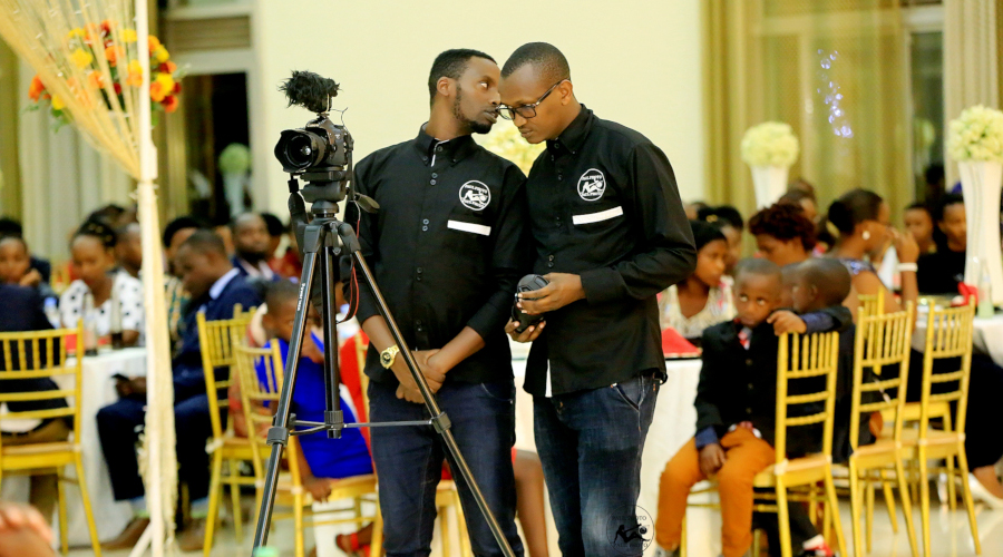 Mutabaro with his another employee covering one of the events. / Courtesy photos