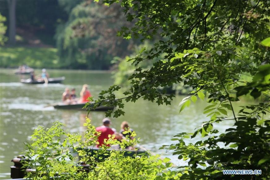 People ride boats in Central Park in New York City, the United States, July 21, 2019. The highest temperature hit 36 degrees Celsius in New York City on Sunday as a result of a heat wave