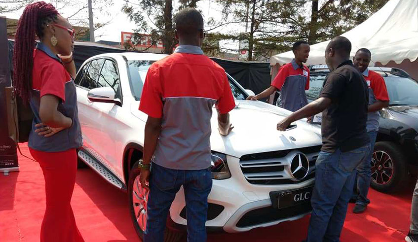 The u2018Shyuha auto showu2019 staff with one of the cars displayed at Petit Stade last  weekend. /All photos by J. P. Nkurunziza.
