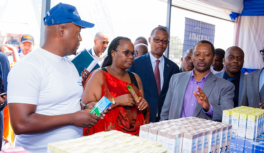 Gerardine Mukeshimana, Rwandan Minister of Agriculture and Animal Resources, Parfait Basubizwa The Vice Mayor for of Economic Development Affairs together with Anastase Shyaka the Minister for Local Government inspecting one of the stalls during the Agricultural Expo.