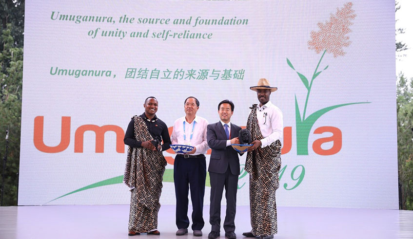 Outgoing Rwanda ambassador to China Charles Kayonga (R) exchange gifts with a Chinese official during Umuganura celebration in Beijing yesterday. Frederic Byumvuhore.