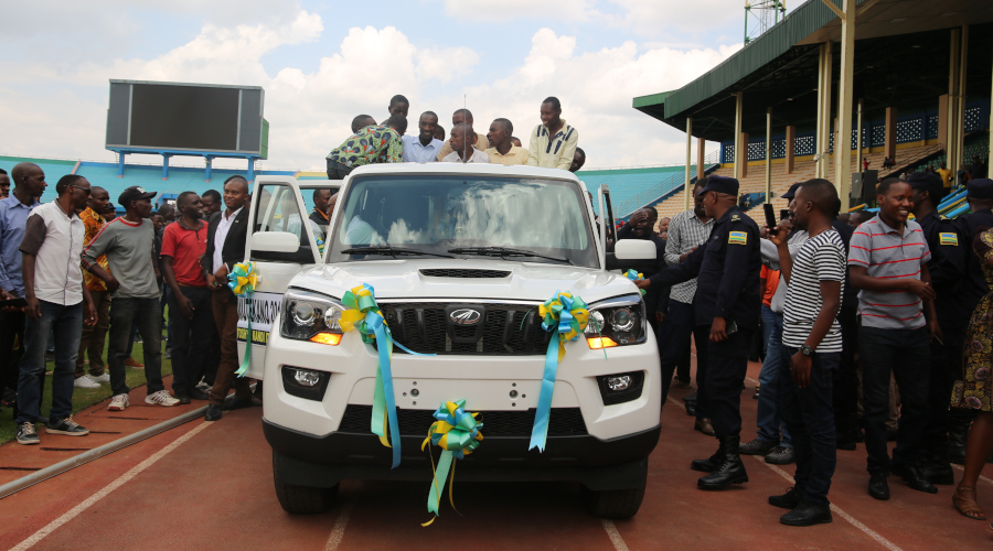 Kimironko residents board a new Mahindra Scorpio double cabin vehicle that they won after the sector was chosen the cleanest and safest on Saturday. / Craish Bahizi