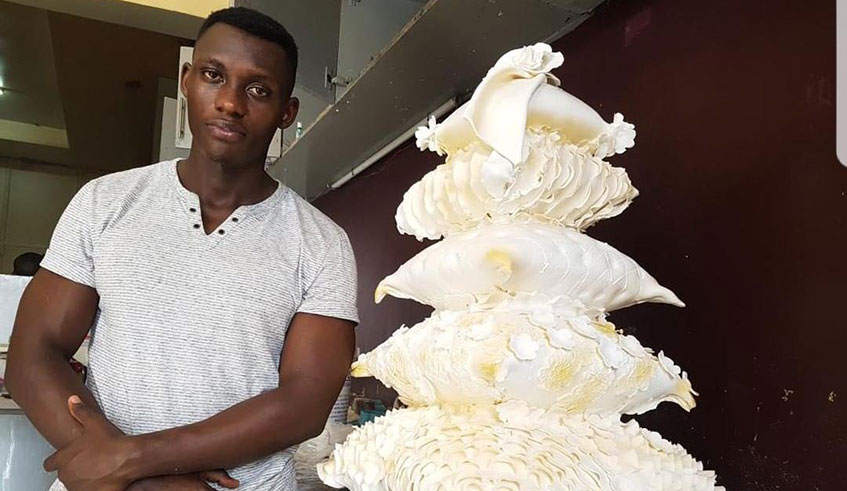 Niyonsenga poses for a photo before some of the cakes he makes. Photos by Lydia Atieno