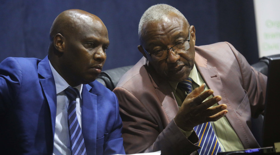 NEC Chairman Prof Kalisa Mbanda (right) chats with Charles Munyaneza, NEC Executive-Secretary, during a past news conference. / Sam Ngendahimana