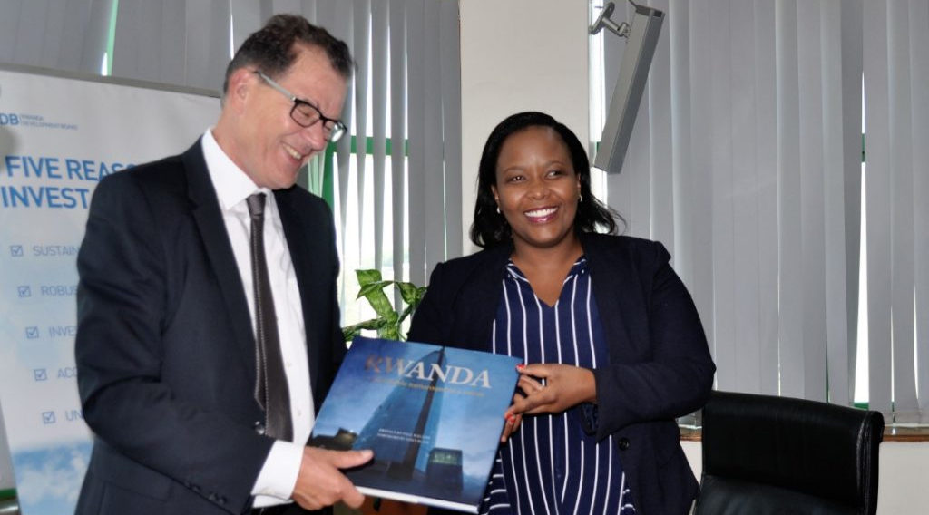 RDB CEO Clare Akamanzi hands over a book that explains Rwandau2019s transformational growth story to Gerd Muller, the German Federal Minister for Economic Cooperation and Development. Germany and Rwanda have agreed to work together in the areas of job creation, skills development and investment, following an agreement that was signed in Kigali yesterday. / Courtesy