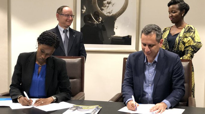 Rwanda Convention Bureau CEO, Nelly Mukazayire, and Amir Rapaport, founder and editor-in-chief of Cybertech, sign a MoU in Rwanda. The signing was witnessed by ICT and Innovation Minister Paula Ingabire and Israeli ambassador to Rwanda Ron Adam. / Courtesy