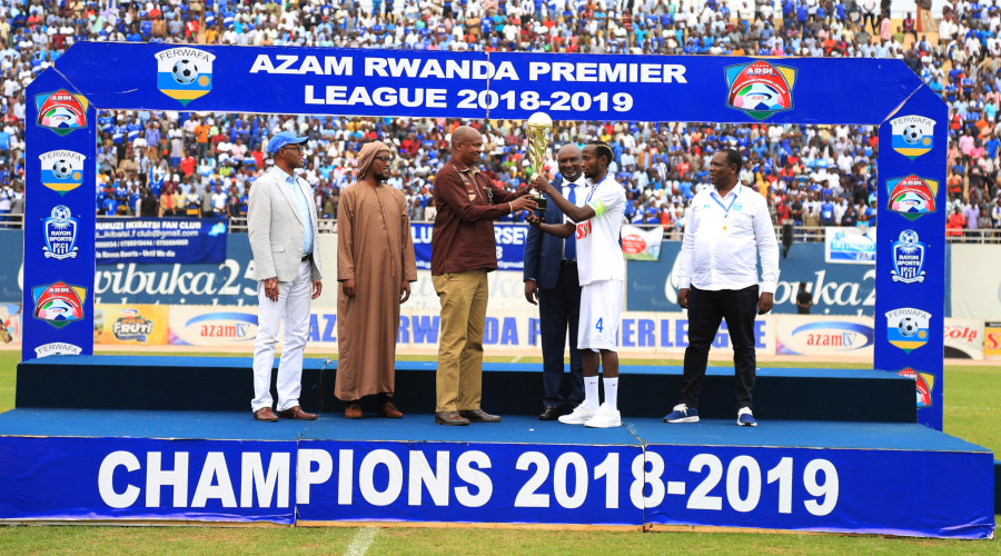 FERWAFA President gives the trophy to former Rayon Sports skipper Thierry Manzi as Rayon Sports won the title last season, Azam TV terminated sponsorship deal with FERWAFA after four years. / Sam Ngendahimana