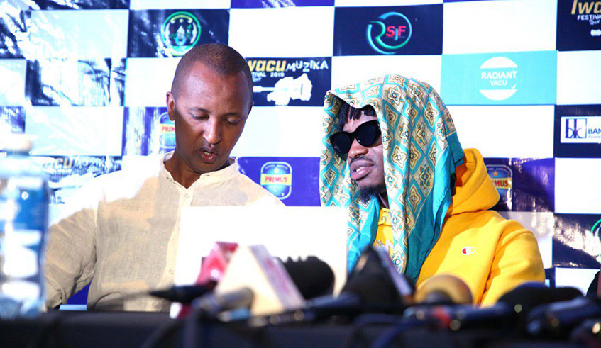 EAP CEO Joseph Mushyoma (L), the brains behind Iwacu Muzika Festival shares a chat with Diamond Platnumz during yesterday's media briefing at Kigali Serena Hotel. Courtesy.
