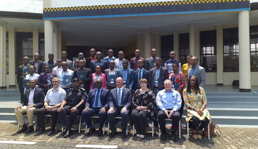 Rwandan investigators who have been trained in interview and interrogation techniques pose with officials from FBI and RIB at National Police College premises in Musanze District. Ru00e9gis Umurengezi.