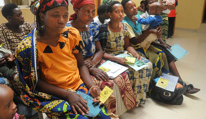 Mothers hold their insurance cards at Gashora health centre. mutuelle de santu00e9 has been facing a funding deficit Rwf14.6 billion every year, according to data from RSSB. (File)
