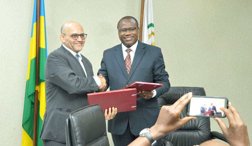 The Minister for Finance and Economic Planning, Uzziel Ndagijimana (right), and the World Bank Country Manager, Said Yasser El-Gammal, exchange documents after signing a $125m credit agreement in Kigali yesterday. Courtesy.
