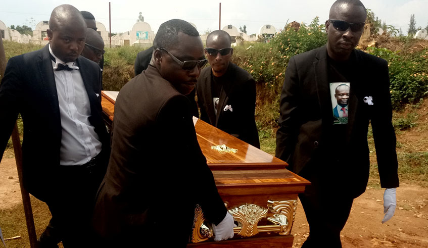 Pallbearers carry a coffin containing Louis Baziga's body for burial in Rusororo Cemetery in Gasabo District, September 2, 2019 (Emmanuel Ntirenganya)