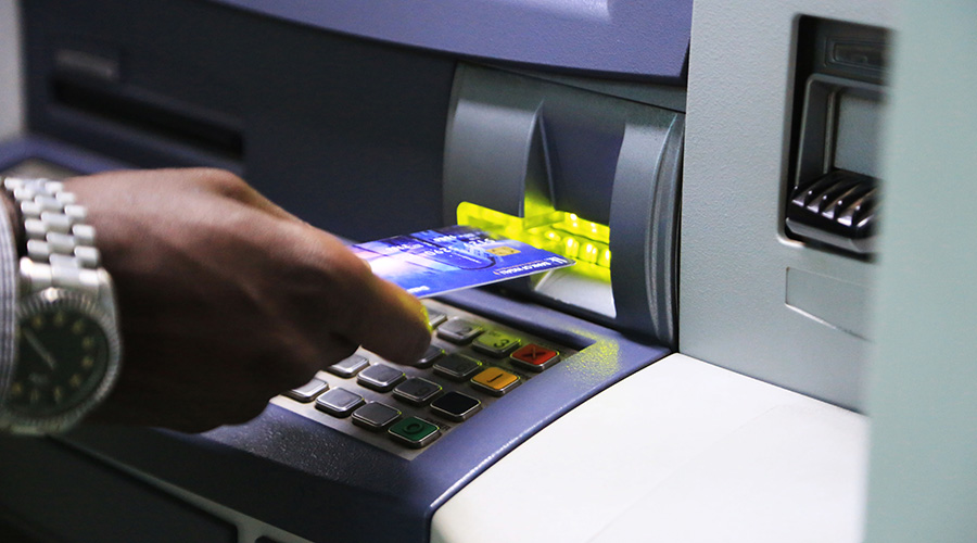 A man uses a visa card to withdraw money from an ATM in Kigali. A new report says Rwanda is among a few African countries that have potential to drive digital evolution. / Sam Ngendahimana