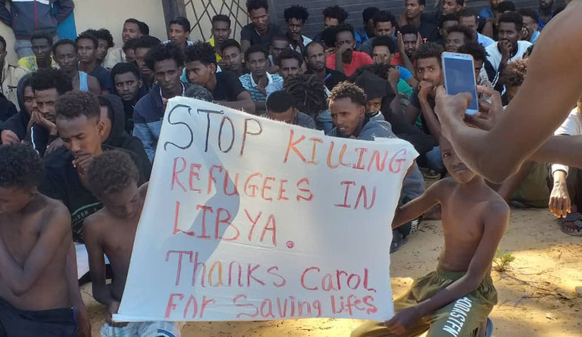 A group of refugees hold a banner desperately pleading for help and safety in Zawiya, Libya. For years, they have been victims of torture, illegal detention, starvation, rape, trafficking, slavery, war crimes.  Net photo.