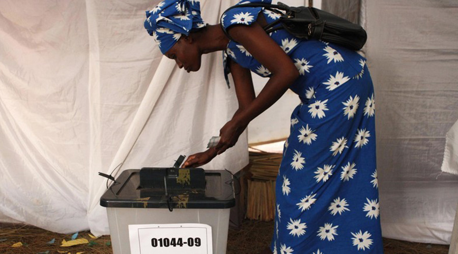 A woman casts her vote. / Courtesy