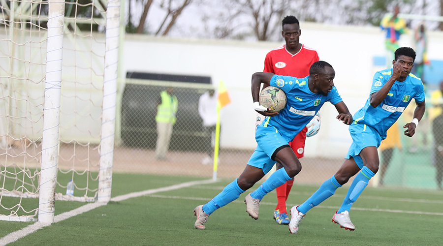 Goal scorer Farouk Sentongo (R) and midfielder Eric Nsabimana (with the ball) rush the ball back in the play after finding a late equalizer at Kigali Stadium on Saturday. / Sam Ngendahimana