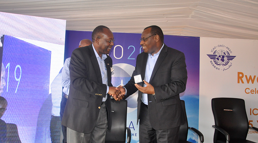 The Minister for Infrastructure Amb. Claver Gatete shakes hands with Barry Kishambo, the Director General of ICAO for Eastern and Southern Region, during the event to the celebrate the 75th anniversary of the Chicago Convention in Muhanga District, yesterday. / Craish Bahizi