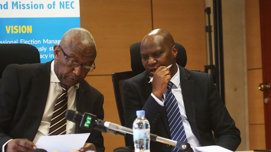 NEC's chairperson Prof. Kalisa Mbanda (left) consults with Charles Munyaneza, the Commissionu2019s Executive Secretary at a past briefing. (File)