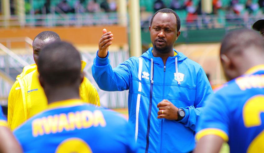 Amavubi coach Vincent Mashami speaks to his players on Monday after leading his final training session at Amahoro Stadium. Saddam Mihigo.
