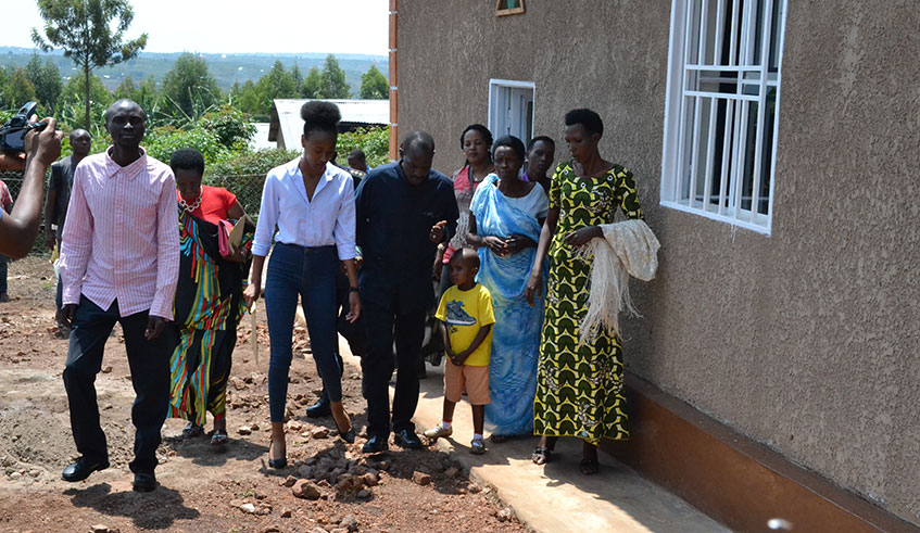 Akiwacu (C), handed over the homes to four Genocide survivors in Rwamagana District.   Photo by Eddie Nsabimana.