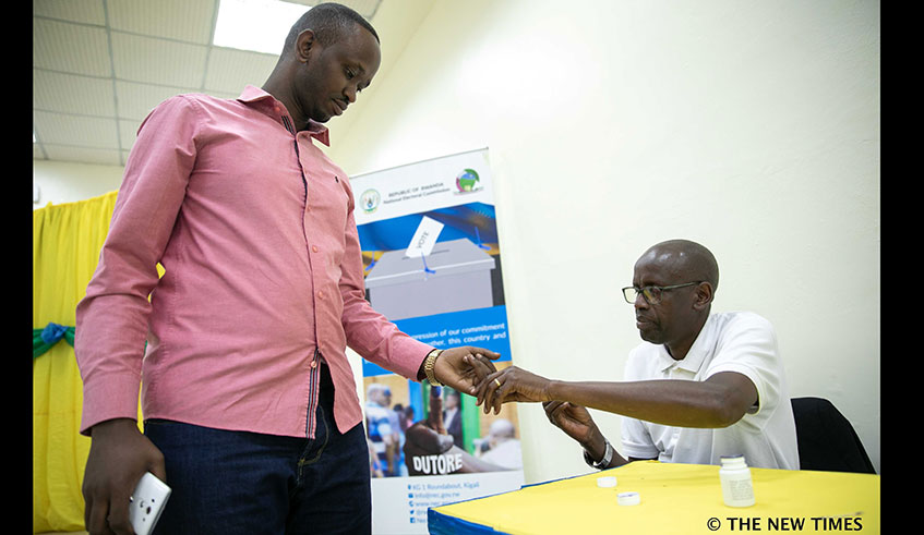 A voter gets his finger inked by an election official at the University of Rwandau2019s College of Science and Technology polling station in Kigali yesterday. Emmanuel Kwizera.