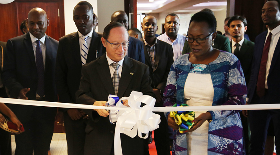 Amb. Ron Adam, the Israeli envoy to Rwanda, and Betty Mahugu, founder of Israel Experience Transforming Africa, cut a ribbon to officially launch the programme in Kigali on Friday. / Courtesy