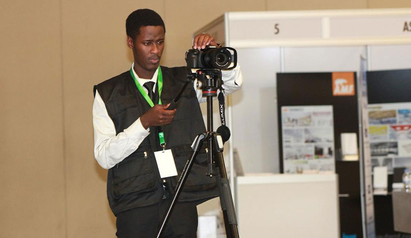 Sam Asiimwe while covering a seminar at Kigali Convetion Center, last year. Courtesy photos.