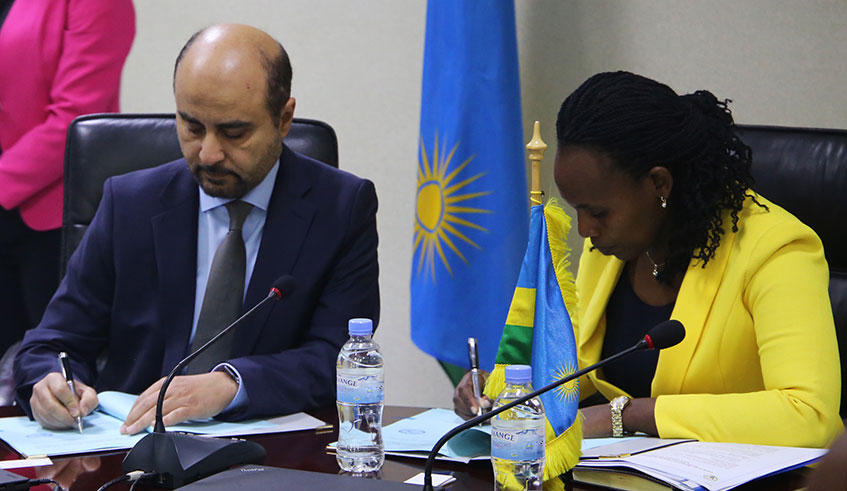 Claudine Uwera, the Minister of State in charge of Economic Planning (right), and OPEC Director-General Abudulhamid Al-khalifa sign the agreement in Kigali yesterday. Craish Bahizi.