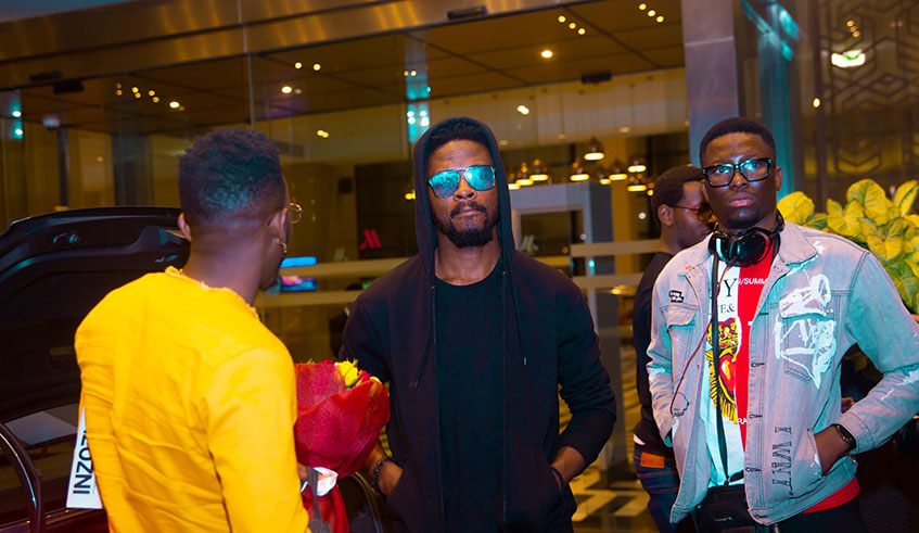 Johnny Drille shortly after arriving at Kigali International Airport, where he promised his fans a great performance on Friday. Courtesy.