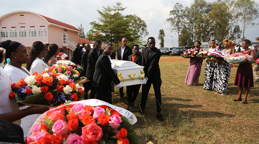 People carry caskets containing remains of more than 100 victims of the 1994 Genocide against the Tutsi that were retrieved from a mass grave in Rwezamenyo Sector, Nyarugenge District on Tuesday. The remains were interred at Kicukiro Memorial yesterday. / Sam Ngendahimana