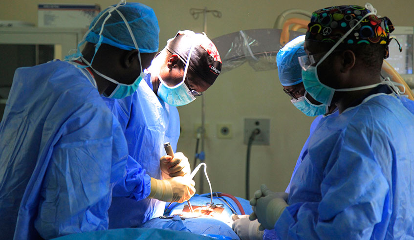 Prof Alexis Butera (2nd left) leads a team of doctors while operating a patient at King Faisal Hospital. Sam Ngendahimana.
