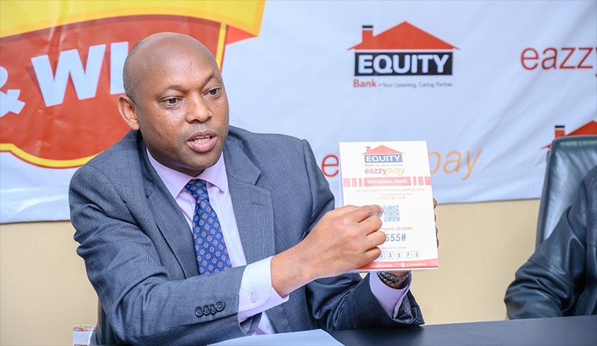 Equity Bank Rwanda MD Hannington Namara speaks to the media during the launch of EazzyPay in Kigali yesterday. James Peter Nkurunziza.