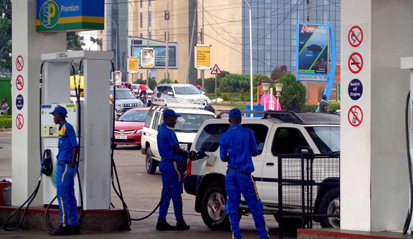A pump attendant refills a caru2019s fuel tank. The Government seeks to increase strategic fuel reserves to 100,000 cubic metres by the end of next year after the Auditor Generalu2019s report exposed delays in expanding the facilities.  (Photos by Craish Bahizi)