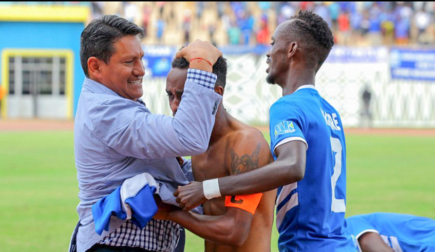 Rayon Sports head coach Janvier Martinez Espinosa hugs his players during a recent match at Amahoro National Stadium in Kigali. Courtesy.