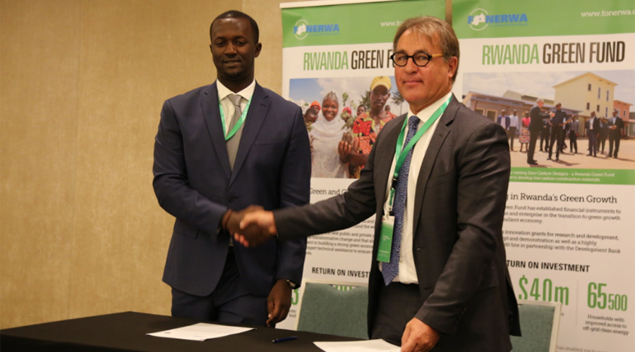 Hubert Ruzibiza, the Chief Executive Officer of FONERWA, and Christophe Nuttell, Executive Director of 20 Regions of Climate Action, signing an MOU to develop smart green cities in Rwanda.