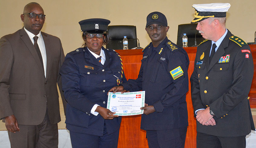 DIGP in charge of Operations, Felix Namuhoranye gives a certificate to one of the course participants as EASF Joint Chief of Staff,  Maj. Gen. Charles Rudakubana and Denmark representative to EASF look on