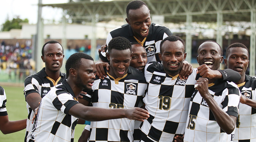 Danny Usengimana (#19) celebrates with teammates after scoring his first goal during APRu2019s 3-0 win over Etincelles at Kigali Stadium on Saturday. / Sam Ngendahimana