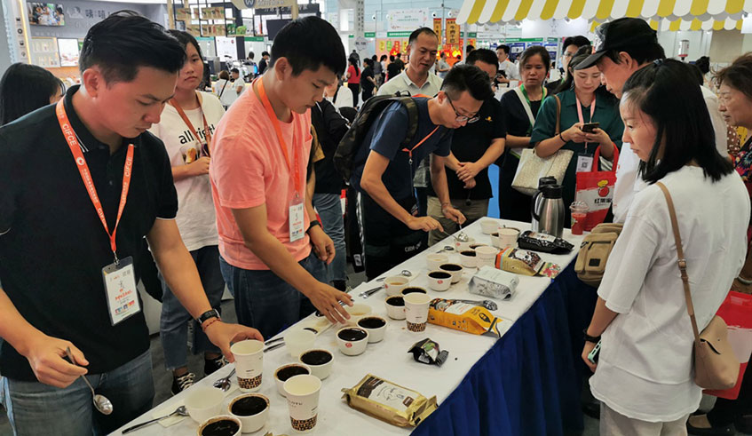 A group of Chinese check out Rwandan roasted coffee during the China International Food & Catering Expo held last month in Changsha city, Hunan Province. Photos by Frederic Byumvuhore.